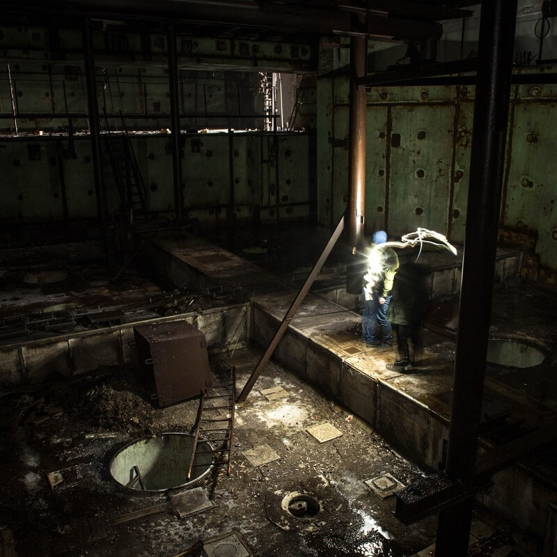 "Contemporary visitors explore the central chamber of Chernobyl Reactor Block 5. This unit was never finished and today the structure is (officialy) off-limits to tourists", Darmon Richter