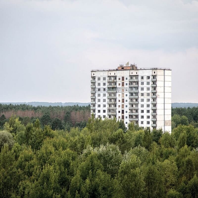 "A residential building on the outskirts of Pripyat. It's hard to tell where the city starts and ends anymore", Darmon Richter. 